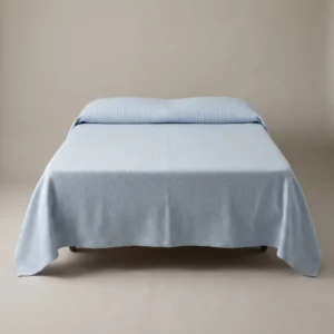 Hospital bedspreads: pale blue ribcord woven bedspread on a hospital bed by International Linens
