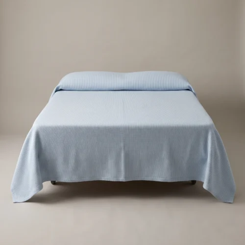 Hospital bedspreads: pale blue ribcord woven bedspread on a hospital bed by International Linens
