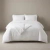 Hotel duvet covers: white satin-stripe duvet cover on a king hotel bed by International Linens