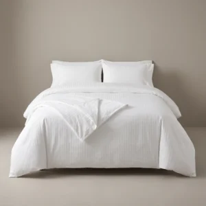 Hotel duvet covers: white satin-stripe duvet cover on a king hotel bed by International Linens