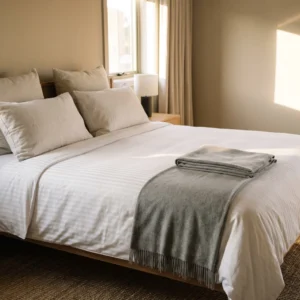Hotel duvet covers in use: white satin-stripe duvet cover on a king hotel bed by International Linens