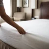 Hotel fitted sheets in use: white deep-pocket fitted sheet on a hotel mattress by International Linens