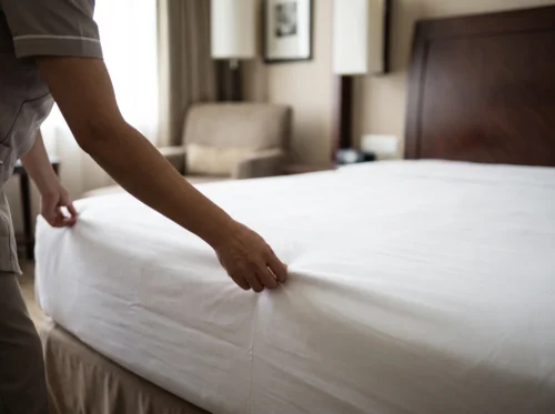 Hotel fitted sheets in use: white deep-pocket fitted sheet on a hotel mattress by International Linens