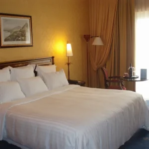 Hotel bed with white sateen sheets