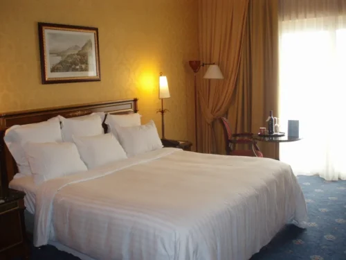 Hotel bed with white sateen sheets