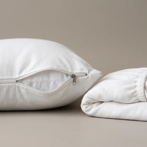Pillow protectors: white zippered pillow protector on a standard pillow by International Linens
