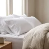 Pillow protectors in use: white zippered pillow protector on a standard pillow by International Linens