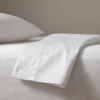 Sateen hotel sheets: white sateen and satin-stripe hotel bed linen by International Linens