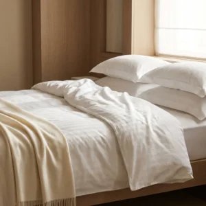 Sateen hotel sheets in use: white sateen and satin-stripe hotel bed linen by International Linens Sateen hotel sheets in use: white sateen and satin-stripe hotel bed linen by International Linens