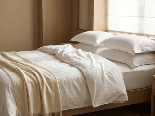 Sateen hotel sheets in use: white sateen and satin-stripe hotel bed linen by International Linens